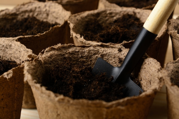 Peat pots with soil and shovel