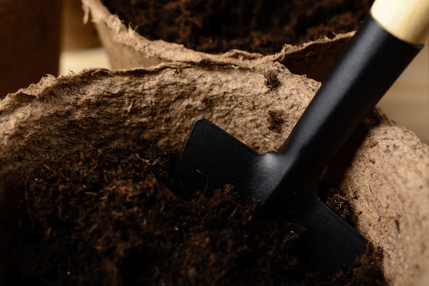 Peat pots with soil and shovel