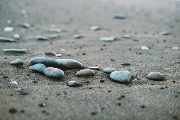 Pebble stones in the sand by the sea beautiful beach background