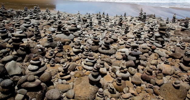 Pebbles balancing next to a beach