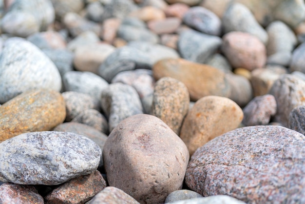 Pebbles on the shore. Round stones on the coast.