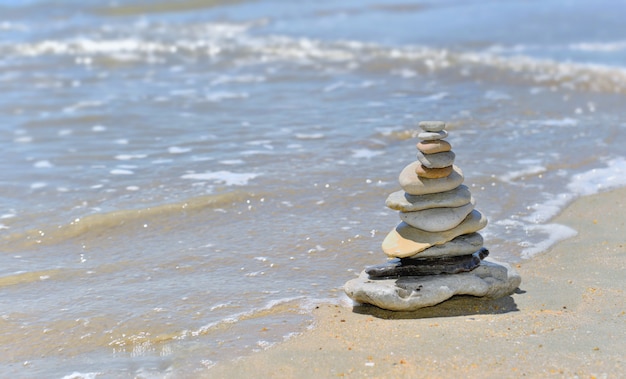 Pebbles stacked on the seaside in sunny day in summer