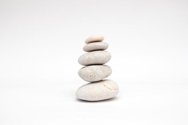 Pebbles stones balance on white background.