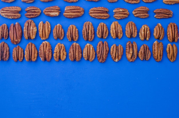 Pecan nut on a blue background. concept of healthy eating