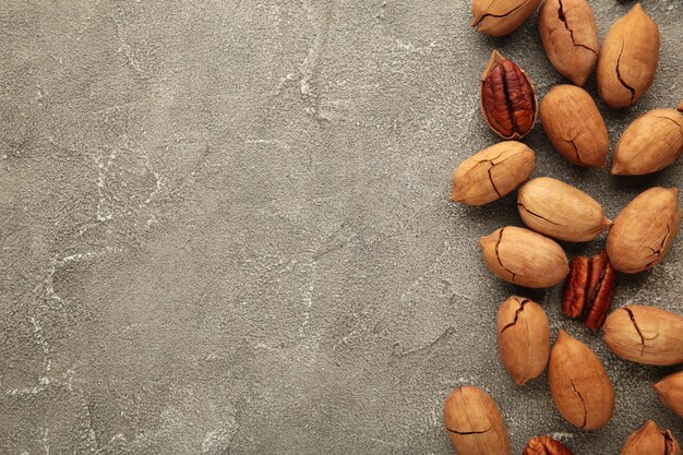 Pecan nuts on a grey table Top view