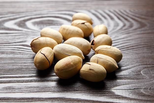 Pecan nuts into shell on wooden table