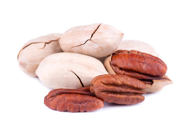 Pecan nuts, isolated on white . Shelled and unshelled pecan.