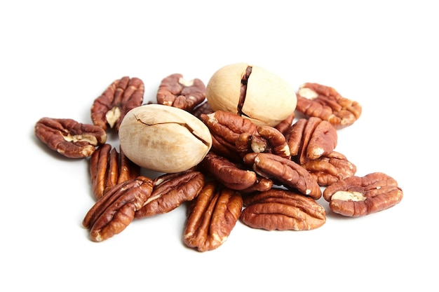 Pecan nuts in shell and peeled pecan halves isolated on a white background