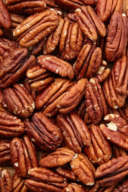 Pecan nuts texture background closeup Heap of pecan halves top view Peeled pecan nuts