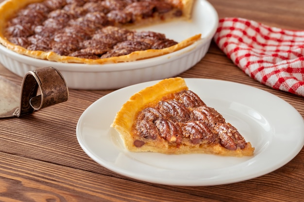 Pecan pie - traditional southern US dessert on wooden table