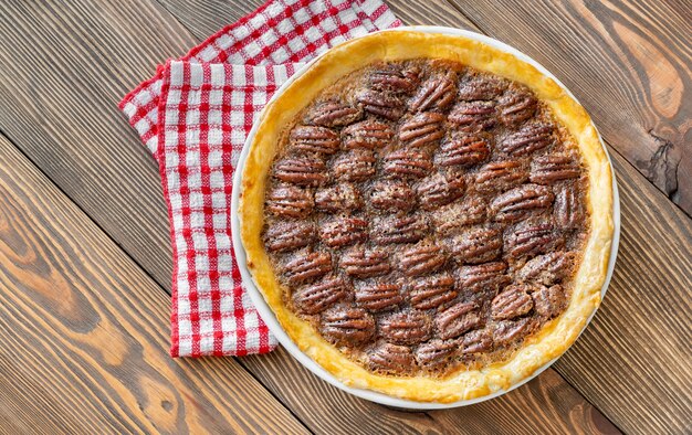 Pecan pie - traditional southern US dessert on wooden table