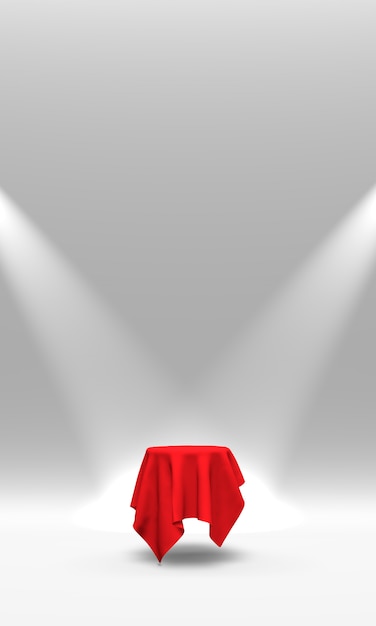 スポットライトで照らされた赤い布で覆われた台座