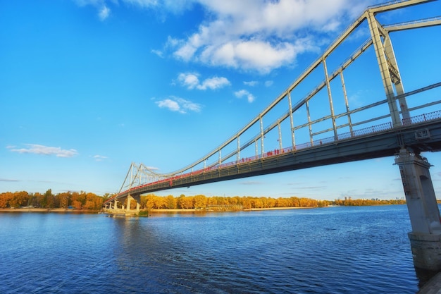 Pedestrian bridge across the Dnieper River autumn landscape Kiev