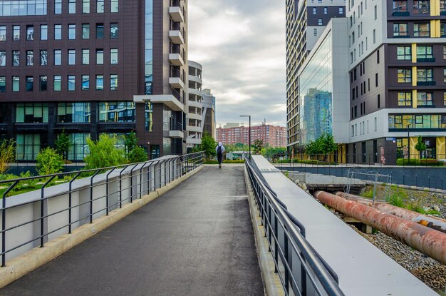 A pedestrian bridge with a man walking on it