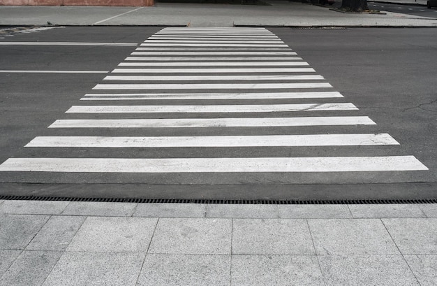 Pedestrian crossing during day pedestrian lanes on asphalt