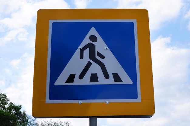 Pedestrian crossing sign against the sky Road safety concept