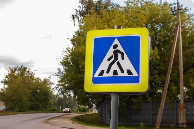 Pedestrian crossing sign near the road closeup