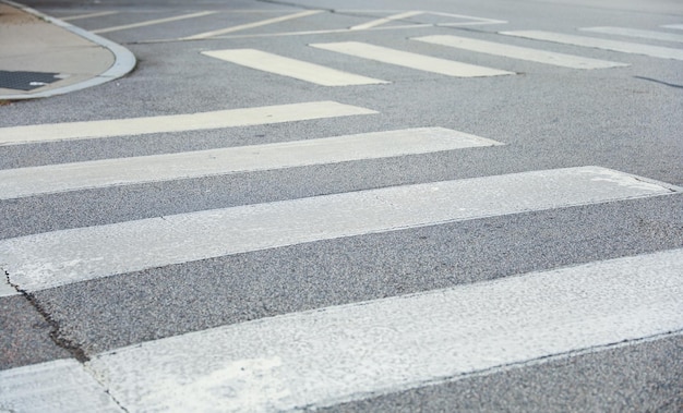 A pedestrian crossing with a white crosswalk on the road