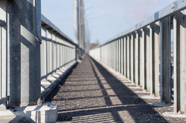 Pedestrian pavement safety barrier on the bridge Sidewalk perspective