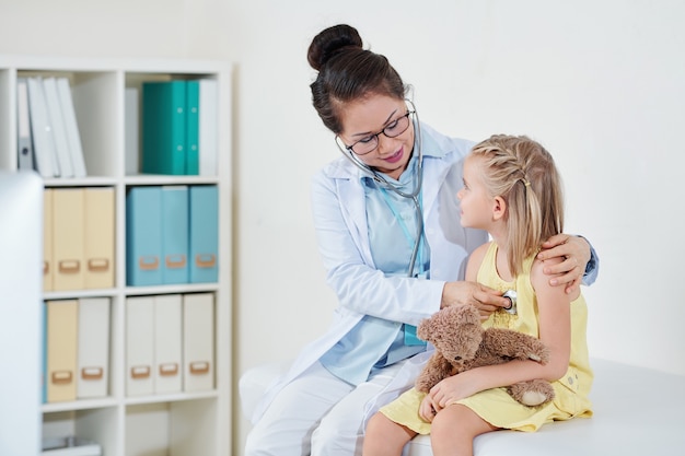 Pediatrician checking respirations