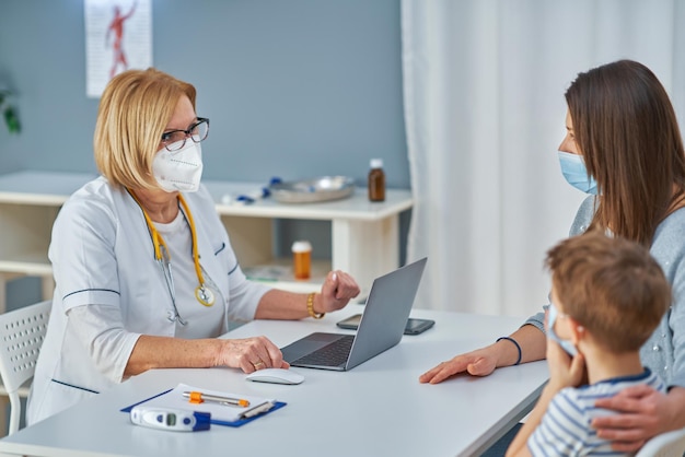 Pediatrician doctor examining little kids in clinic. High quality photo