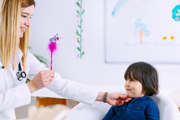 Pediatrician examining little boy's eyesight