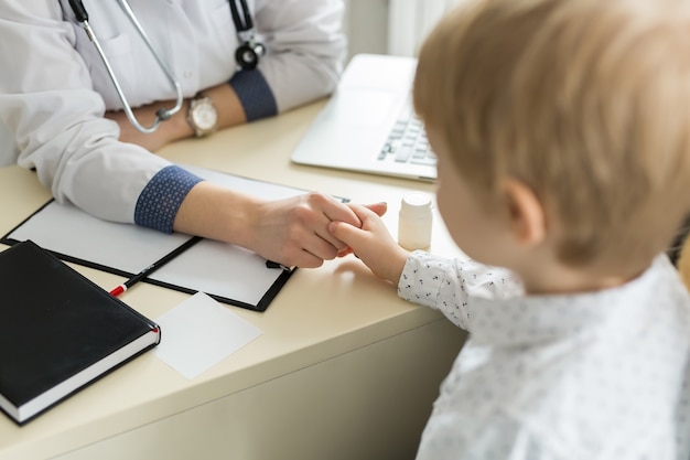 Pediatrician Meeting With Mother And Child In Hospital