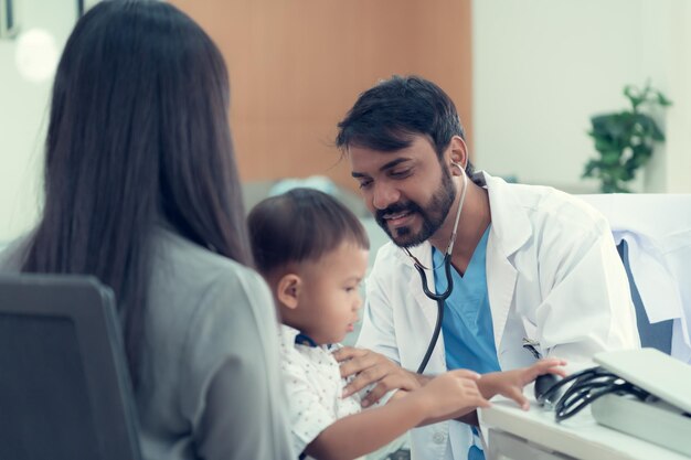 The pediatrician must try to play with the child which parents brought to check the body