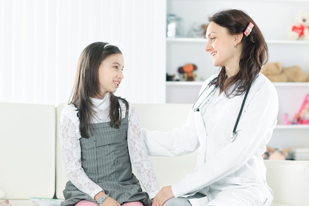 Pediatrician talking positively with a little girlphoto with copy space