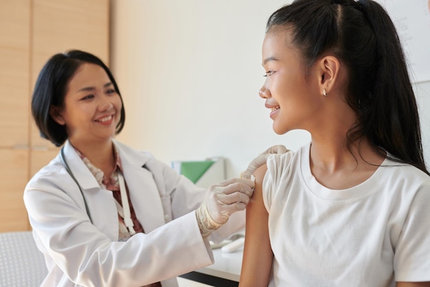 Pediatrician wiping injection site