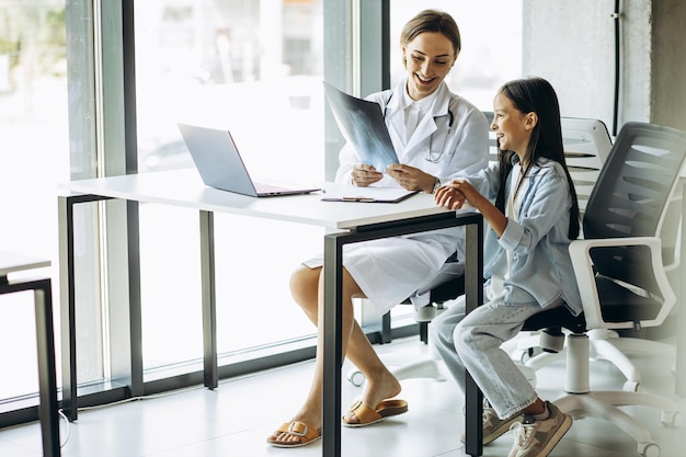 Pediatrician with child having consultation