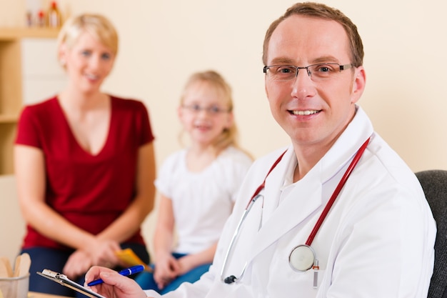 Pediatrician with family in his surgery