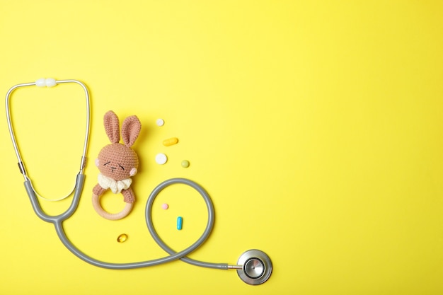 pediatrics concept stethoscope and toy on a light background