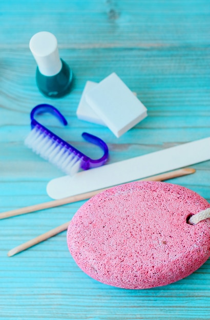 Pedicure accessories with nail polish on wood