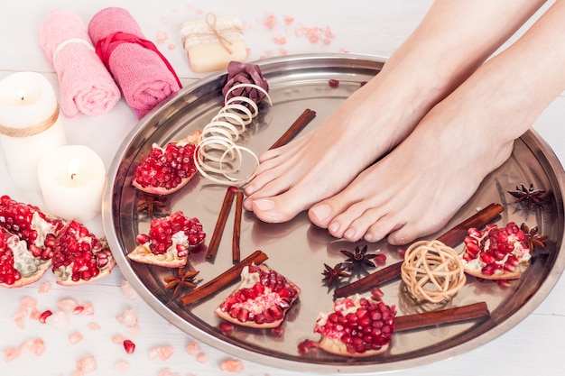 Pedicure in the spa salon with pomegranate, cinnamon and anise