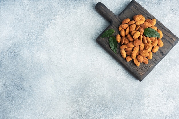 Peeled almonds on a wooden rustic background