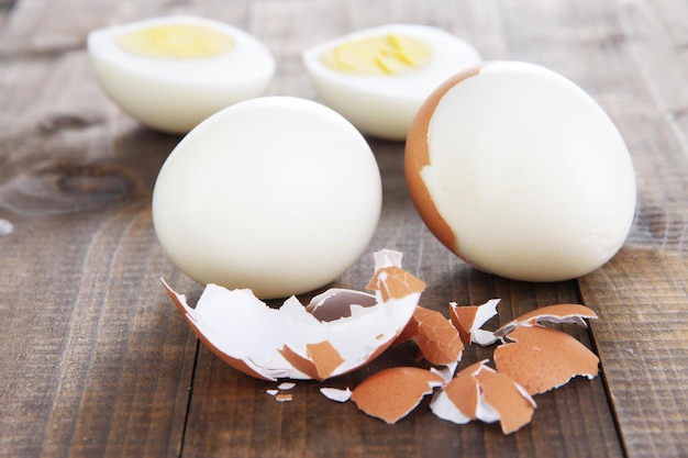 Peeled boiled egg on wooden background