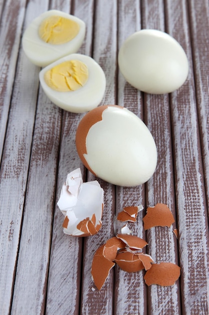 Peeled boiled egg on wooden background