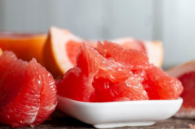 Peeled and divided into parts ripe red grapefruit