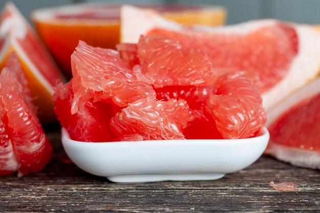 Peeled and divided into parts ripe red grapefruit