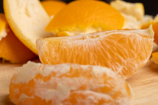 Peeled orange divided into slices on a board peeling a ripe and juicy orange orange