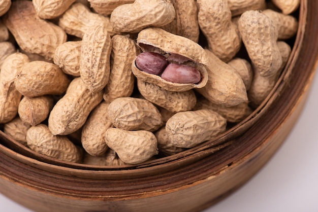 Photo the peeled peanuts are placed among many peanuts