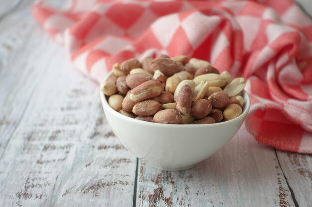 Peeled peanuts in a bowl on table