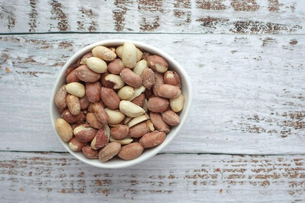 Peeled peanuts in a bowl on table