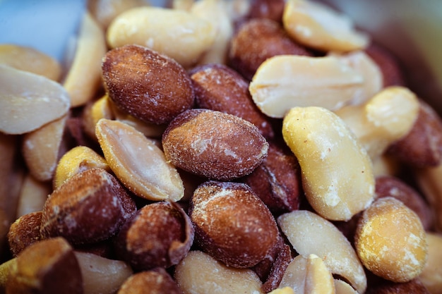 Peeled peanuts on a light surface.