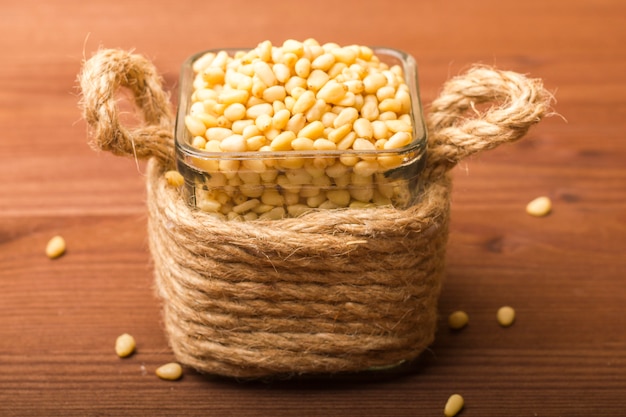 Peeled pine nuts in a glass bowl.