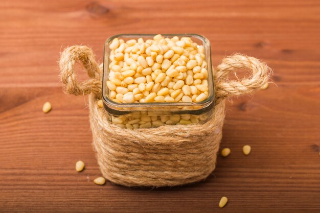 Peeled pine nuts in a glass bowl.