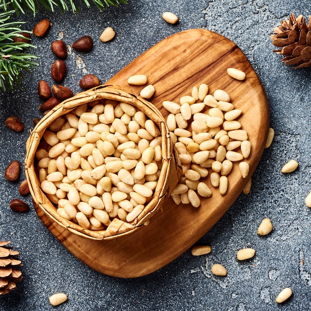 Peeled pine nuts on gray background