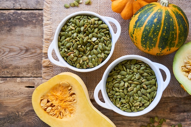 Peeled pumpkin seeds in white bowls