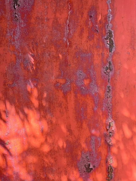 Peeled red paint on metal iron background